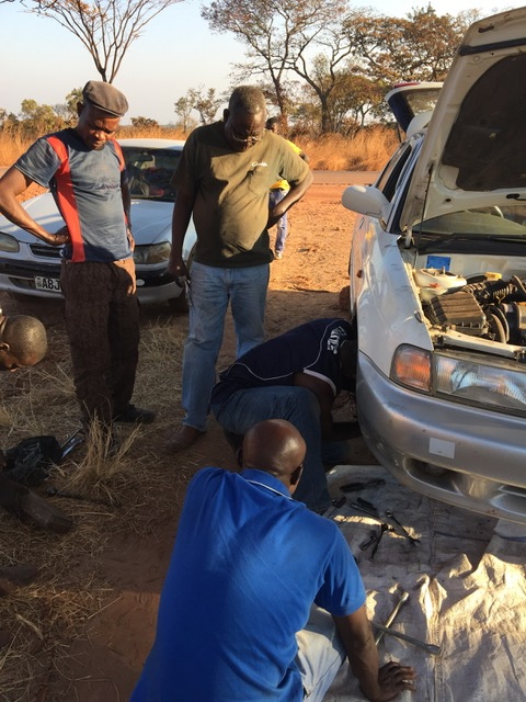 Men repairing Suzuki in Zambia.